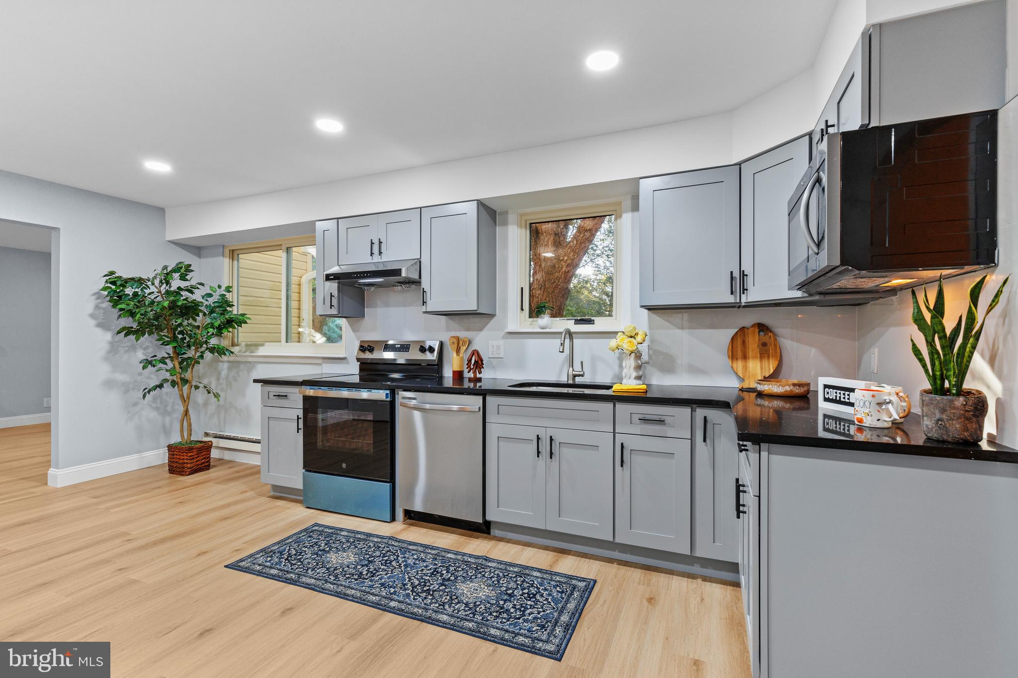 4103 Forrest Road Mount Joy, PA 17552 - Photo 11 of 50 a kitchen with stainless steel appliances granite countertop a refrigerator a stove a sink dishwasher and white cabinets with wooden floor