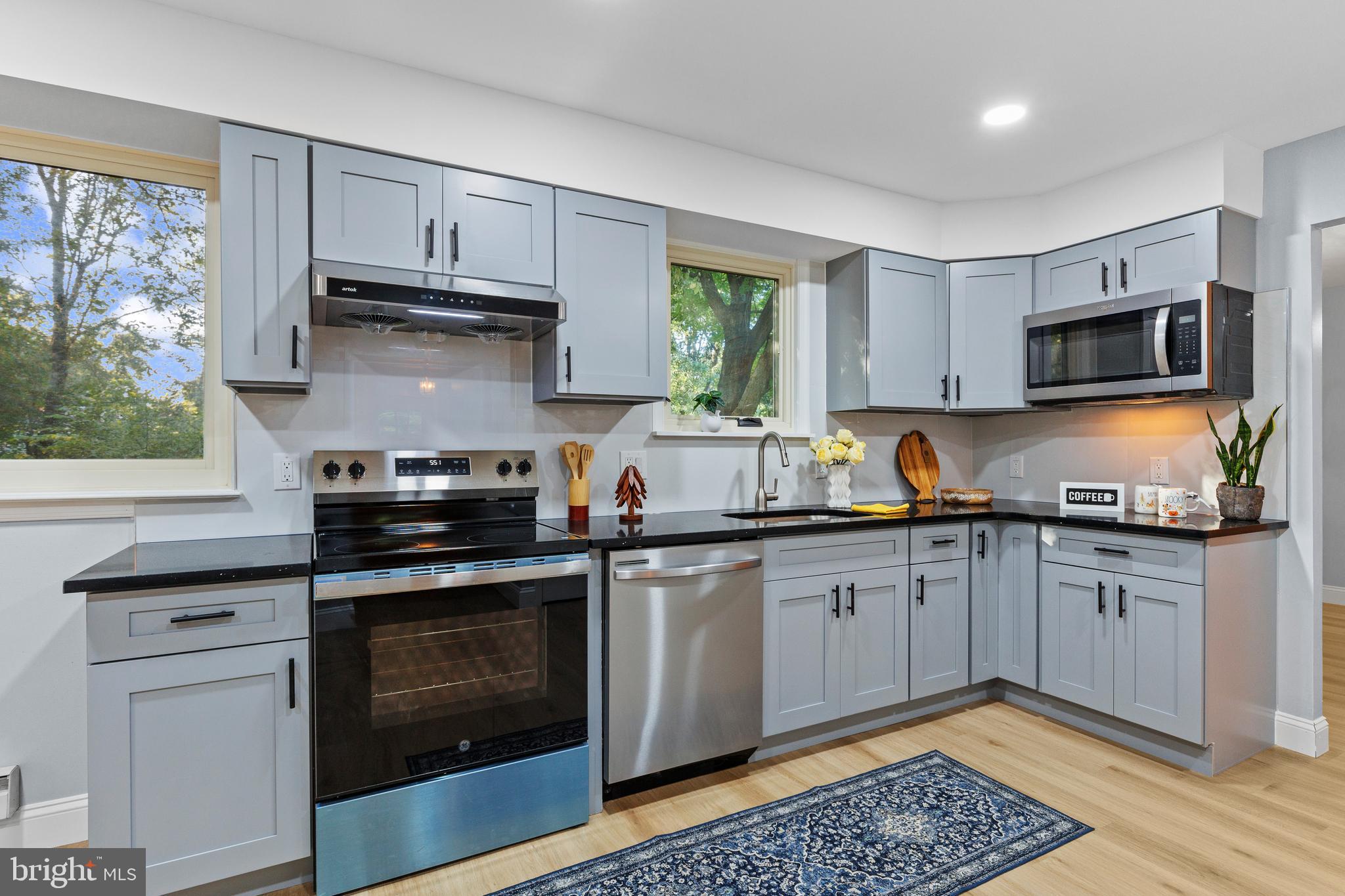 4103 Forrest Road Mount Joy, PA 17552 - Photo 12 of 50 a kitchen with stainless steel appliances granite countertop a stove a sink and a microwave