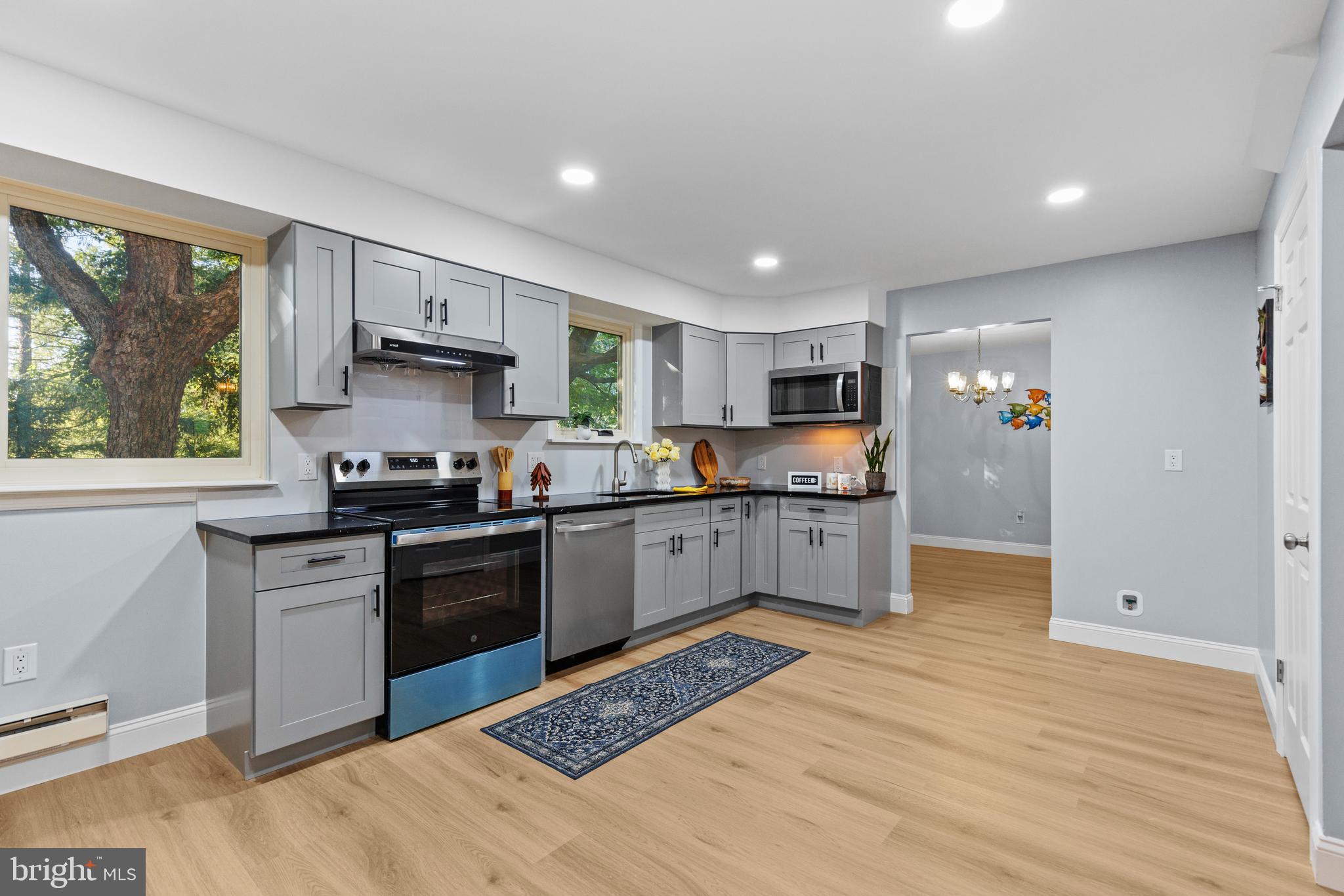 4103 Forrest Road Mount Joy, PA 17552 - Photo 13 of 50 a kitchen with stainless steel appliances granite countertop a stove top oven a sink dishwasher and a refrigerator with wooden floor