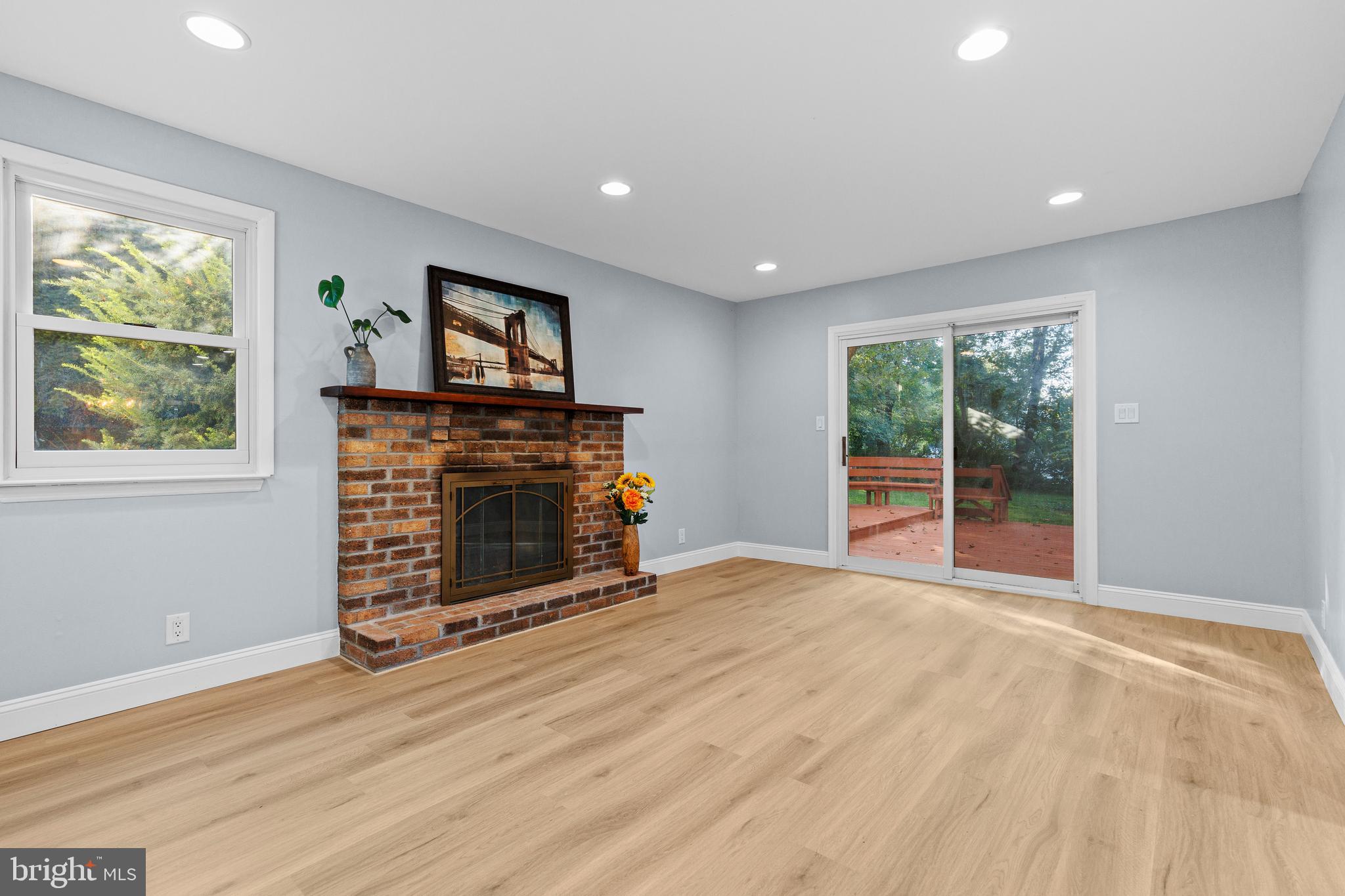 4103 Forrest Road Mount Joy, PA 17552 - Photo 16 of 50 a view of an empty room with wooden floor fireplace and a window