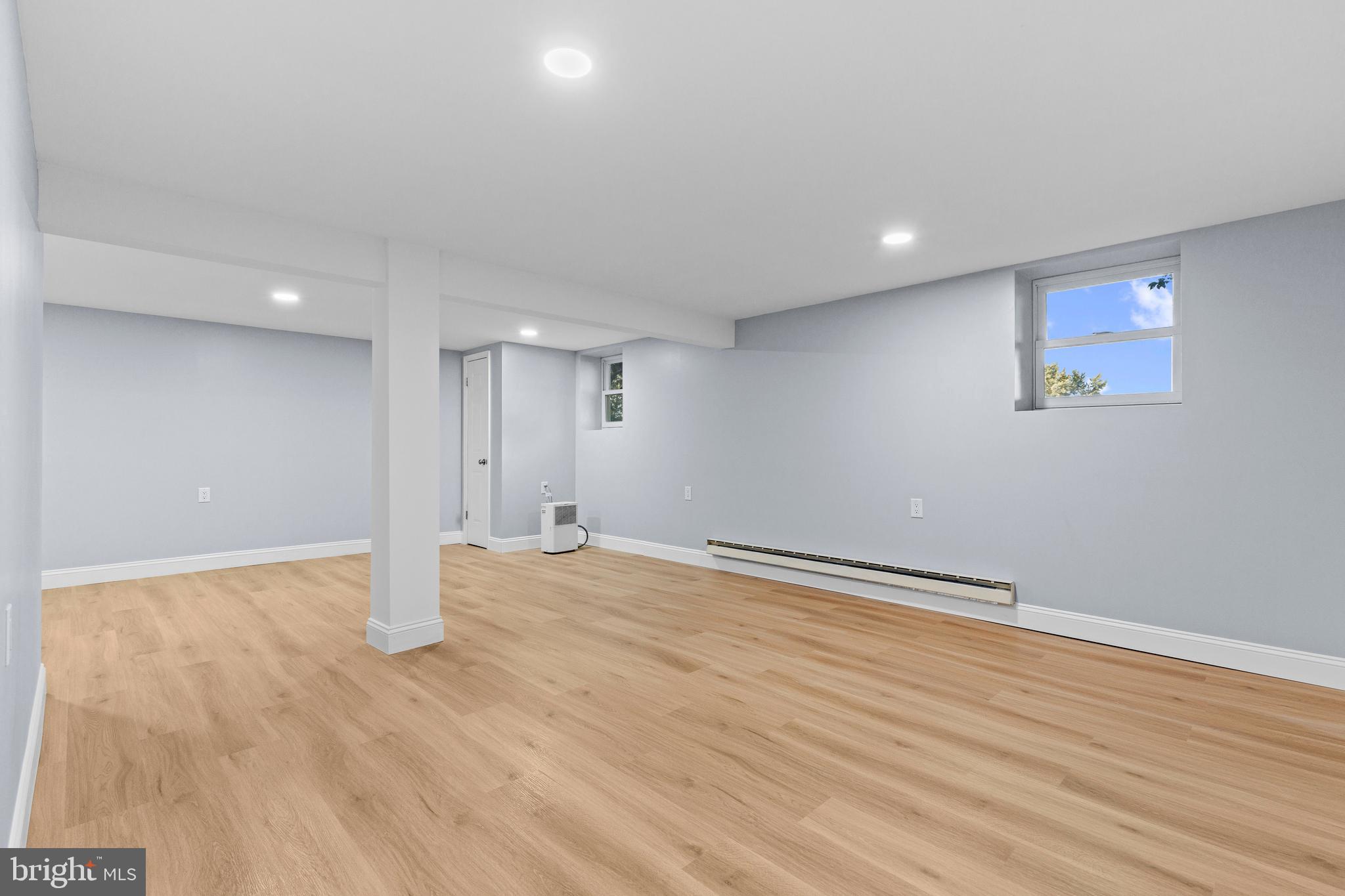 4103 Forrest Road Mount Joy, PA 17552 - Photo 33 of 50 a view of an empty room with wooden floor and painting on the wall