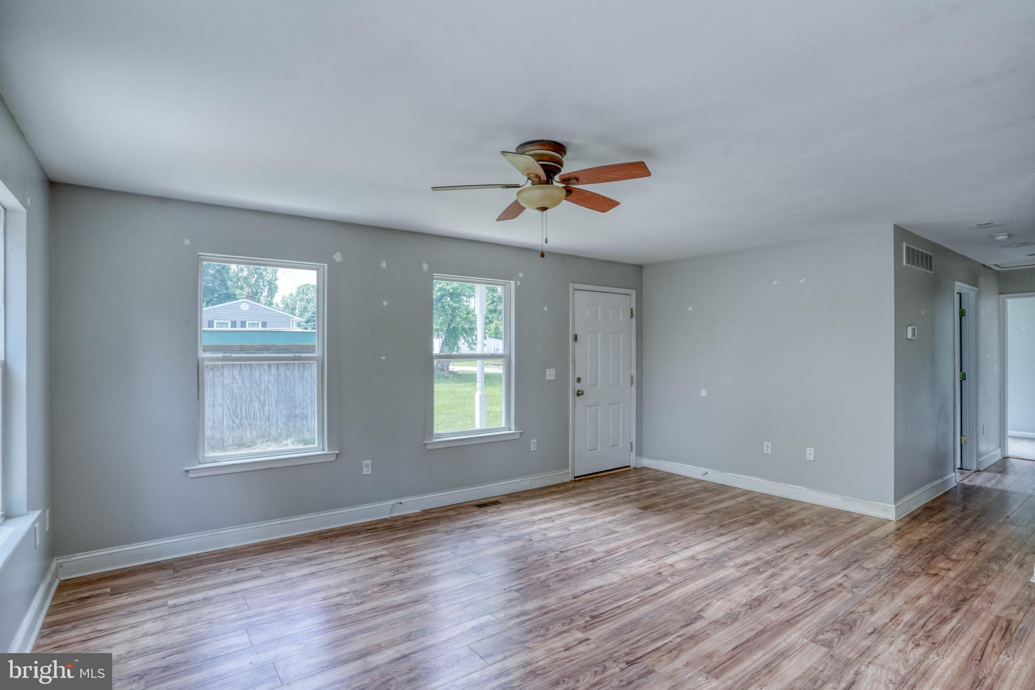 203 Hamilton Street Delaware City, DE 19706 - Photo 8 of 27 a view of an empty room with window and wooden floor
