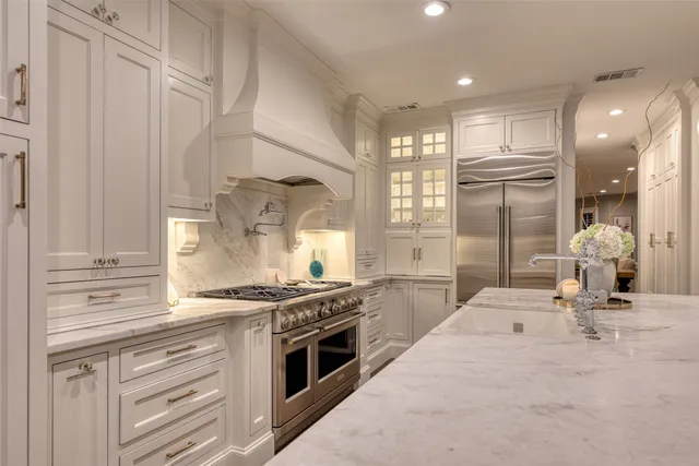 a kitchen with stainless steel appliances granite countertop a stove and a refrigerator