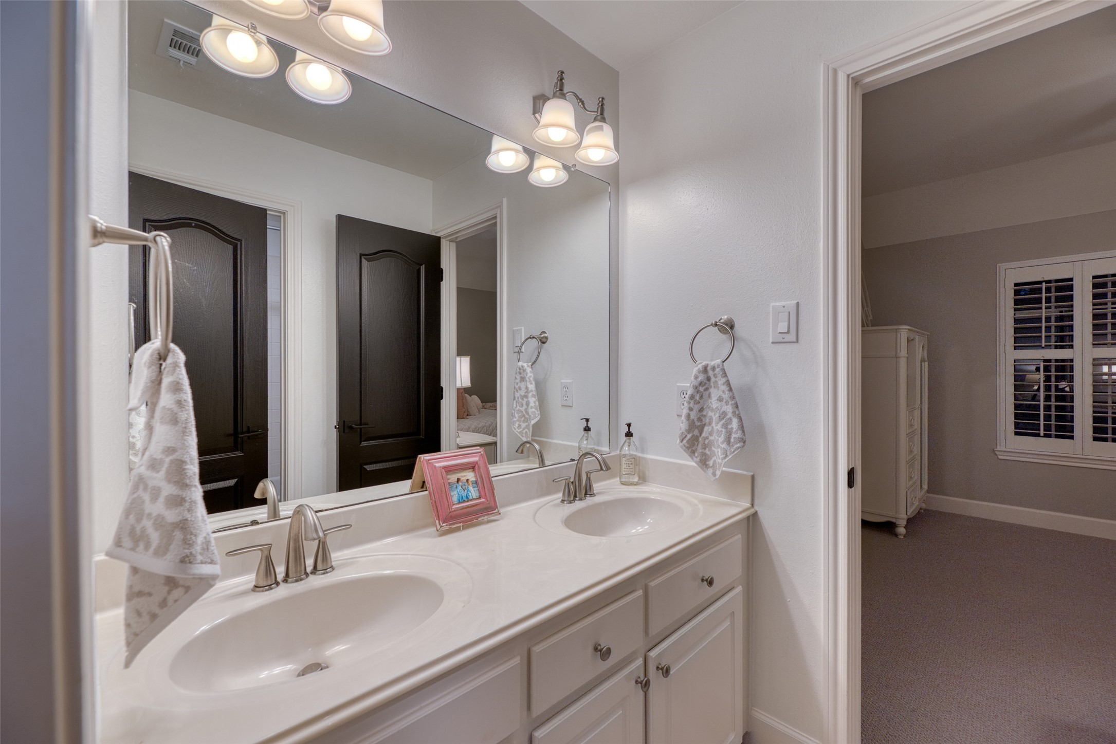 19522 Tamarack Way Houston, TX 77094 - Photo 29 of 50 a bathroom with a double vanity sink and a mirror