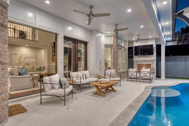 a living room with furniture a fireplace and a floor to ceiling window