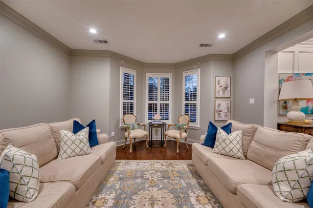 a living room with furniture and large windows