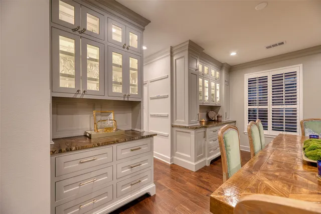 a kitchen with granite countertop a stove and cabinets