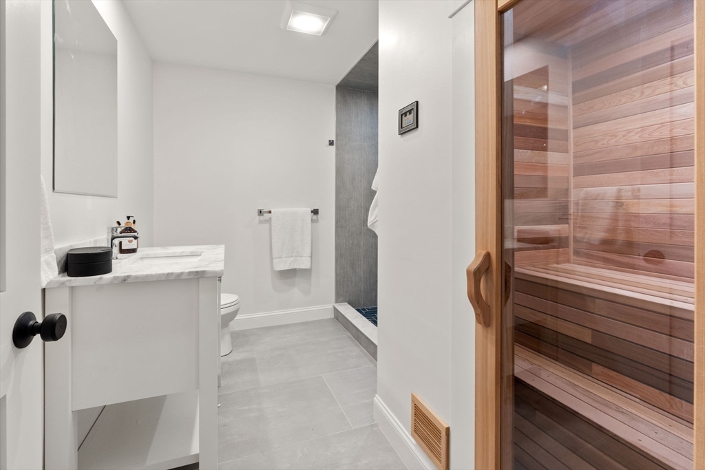 82 Deer Path Lane Weston, MA 02493 - Photo 29 of 42 a bathroom with a sink mirror and shower