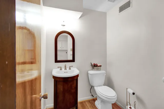 a bathroom with a toilet sink and mirror