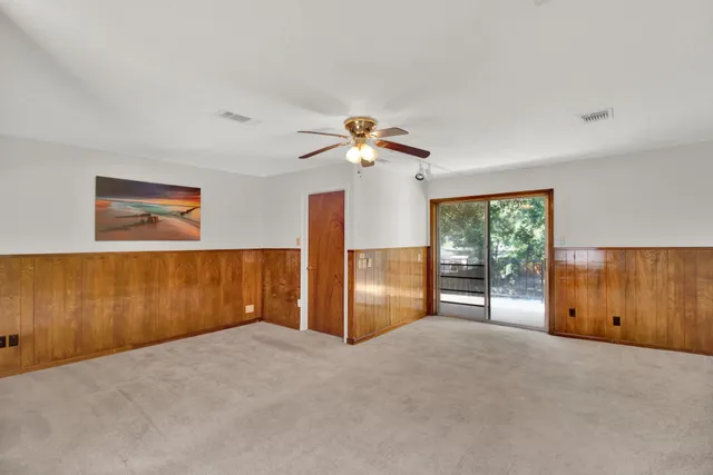 a view of a livingroom with a ceiling fan and window