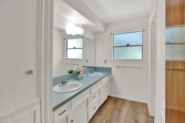 a bathroom with a double vanity sink and mirror