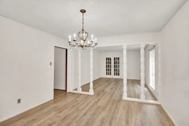 a view of livingroom with chandelier and wooden floor