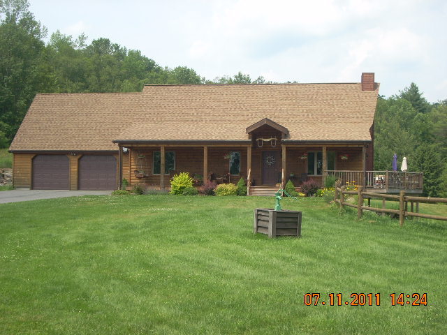 49 S Road Peru, MA 01235 - Photo 1 of 21 a front view of a house with a garden and yard