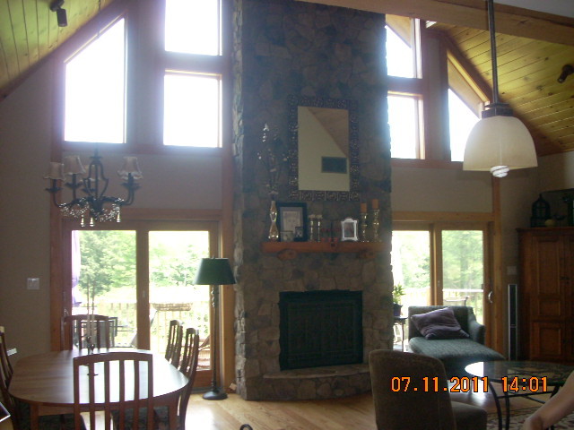 49 S Road Peru, MA 01235 - Photo 5 of 21 a living room with furniture a fireplace and a large window
