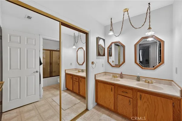 a bathroom with a double vanity sink and mirror