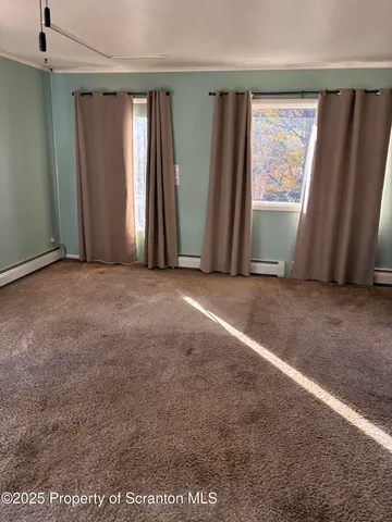 an empty room with windows and closet