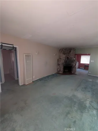 a view of empty room with fireplace