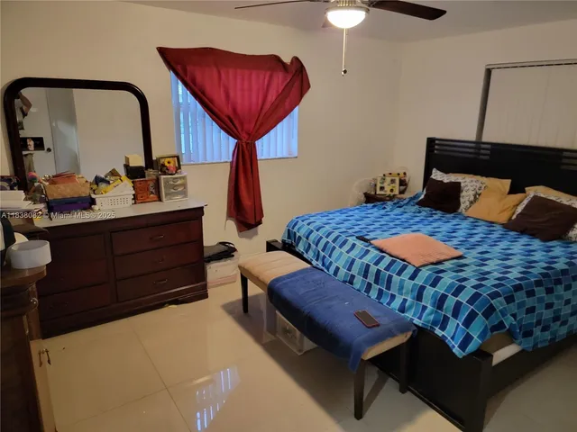 a bedroom with furniture and a mirror