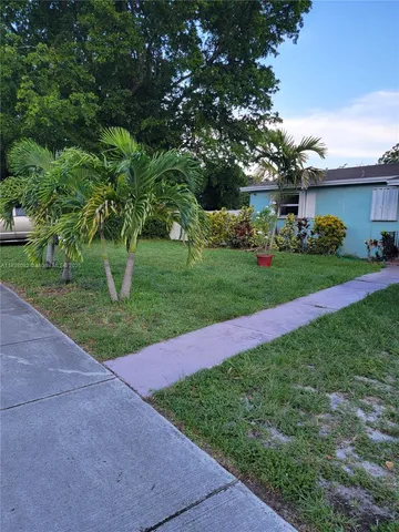 a view of a garden with a building in the background