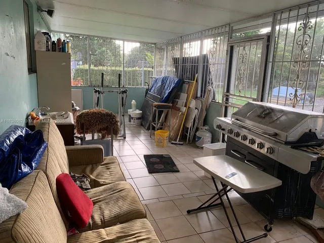 a living room with furniture and a floor to ceiling window