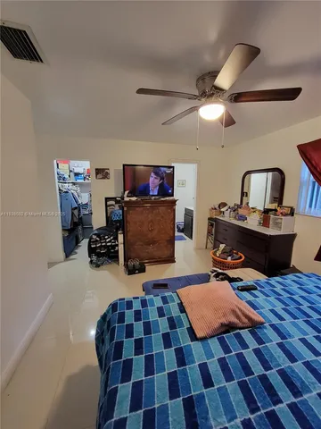 a bedroom with furniture and a rug