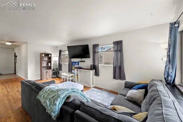 a living room with furniture and a flat screen tv