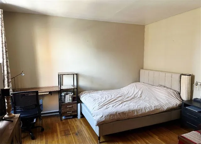 a bedroom with a bed and a lamp on table