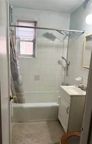 a bathroom with a sink a mirror and a bathtub