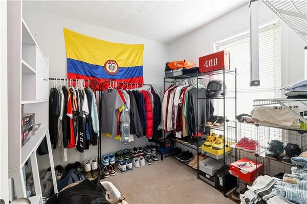 a view of walk in closet with clothes