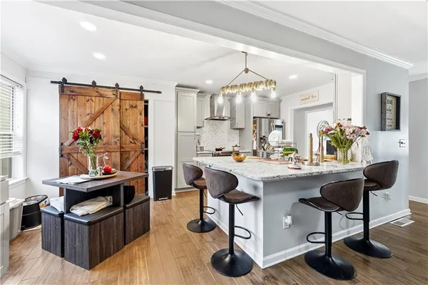 a view of kitchen island dining room and wooden floor