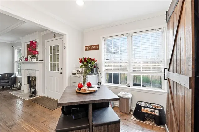 a view of a dining room with furniture and a window