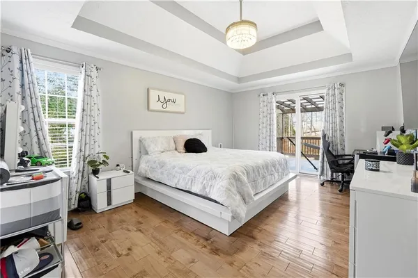 a bedroom with a bed furniture and a large window