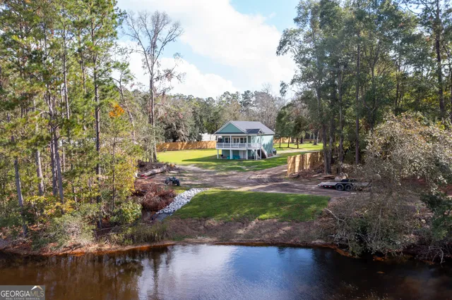 a aerial view of house with yard and swimming pool