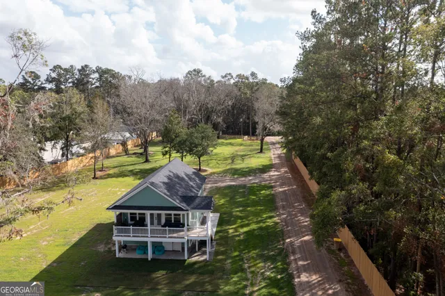 a view of back yard and car parked