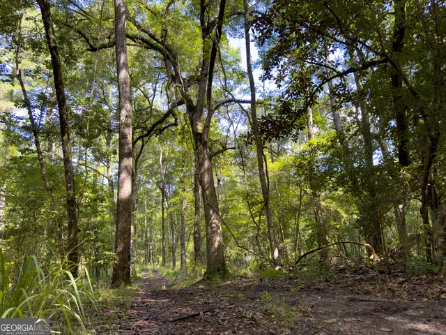 a view of a roof deck with table and chairs a barbeque