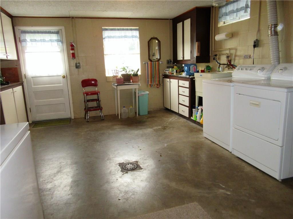 182 Ford City Road Freeport, PA 16229 - Photo 13 of 24 This very large laundry room has built in cupboards and counters.