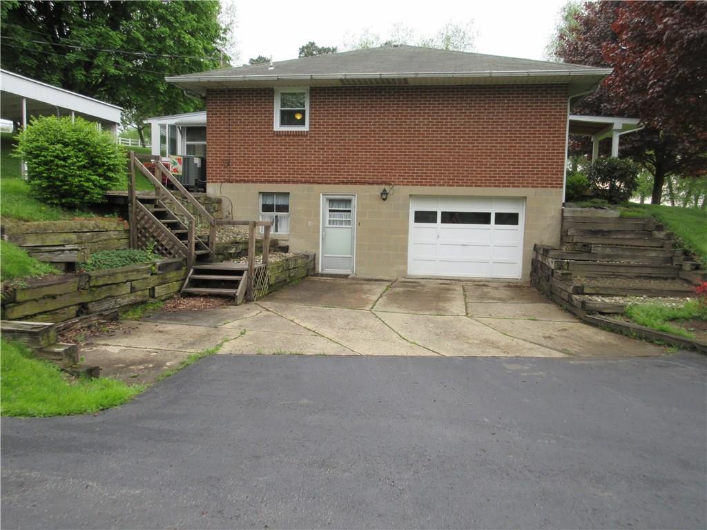 182 Ford City Road Freeport, PA 16229 - Photo 17 of 24 Side view of blacktop and cement driveway, 1 car integral garage, and entrance to the lower level.