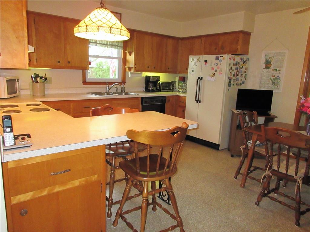 182 Ford City Road Freeport, PA 16229 - Photo 4 of 24 Spacious eat-in kitchen offers plenty of counter space, includes appliances, and opens to the living room, as well as the enclosed sunroom.