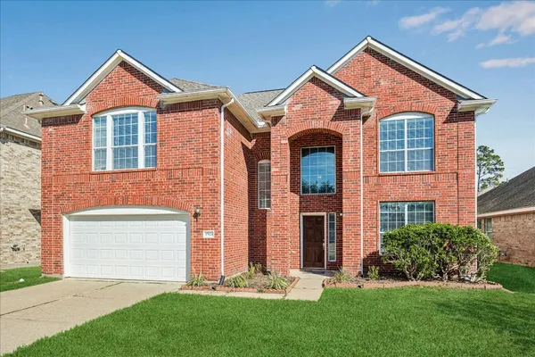 a kitchen with granite countertop a sink stove and cabinets