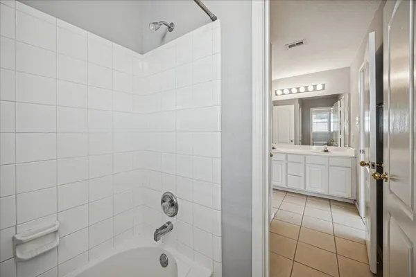 a bathroom with a sink a mirror and a bathtub