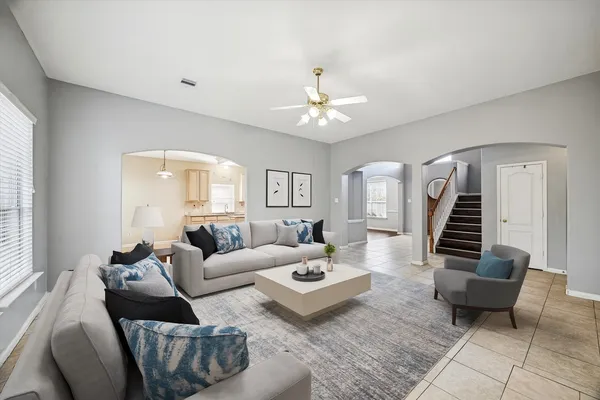 a living room with furniture and wooden floor