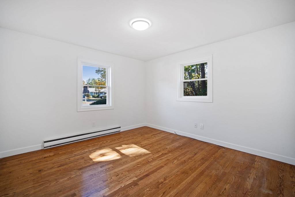 154 County Road Southampton, MA 01073 - Photo 23 of 42 an empty room with a window and wooden floor