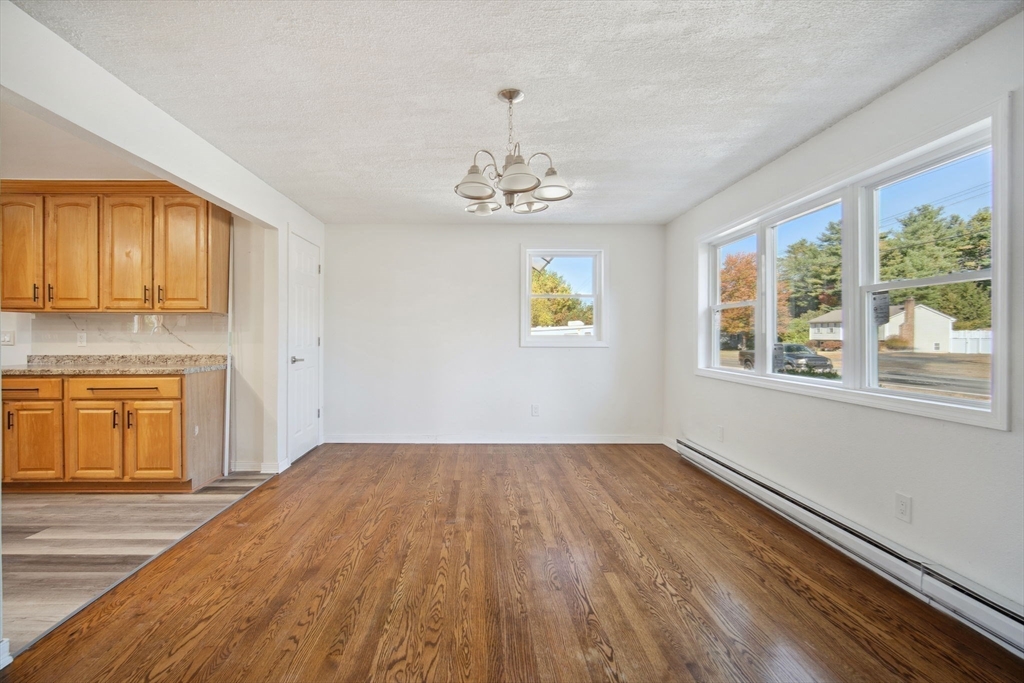 154 County Road Southampton, MA 01073 - Photo 9 of 42 a view of empty room with wooden floor and fan