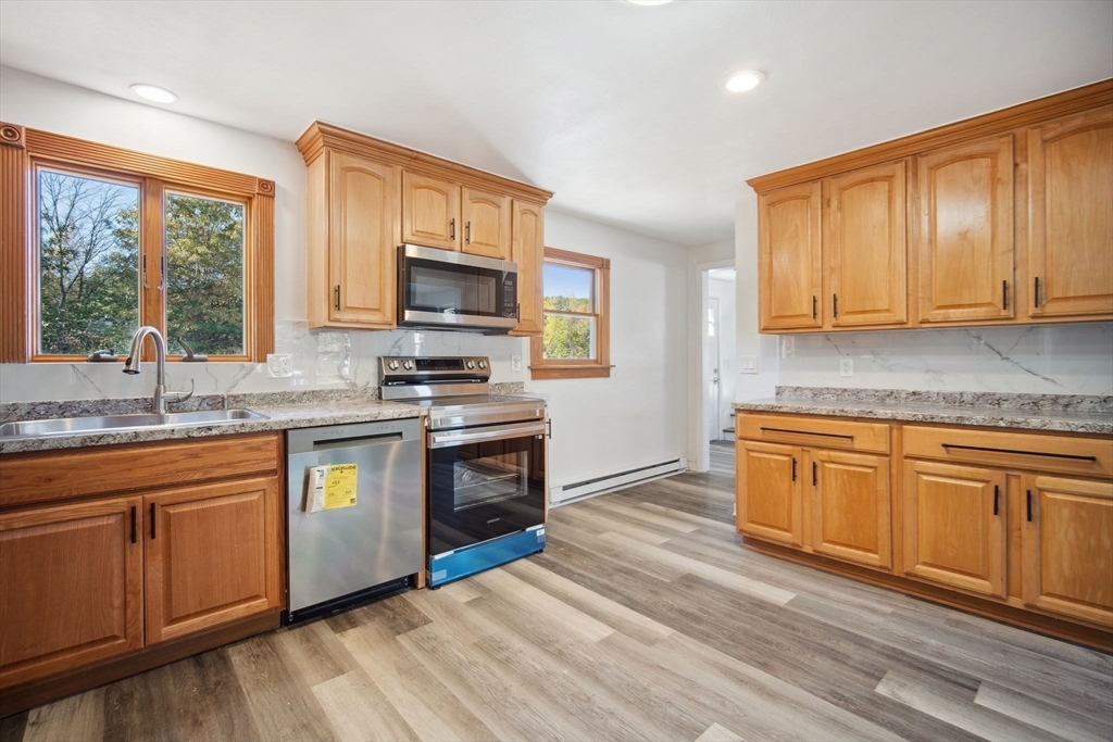 154 County Road Southampton, MA 01073 - Photo 10 of 42 a kitchen with stainless steel appliances granite countertop a stove a sink and a microwave