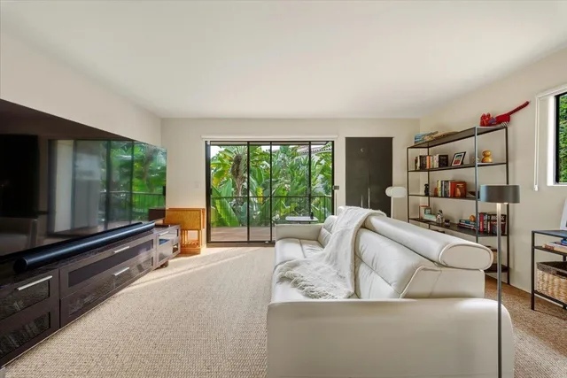 a balcony with wooden floor table and chairs