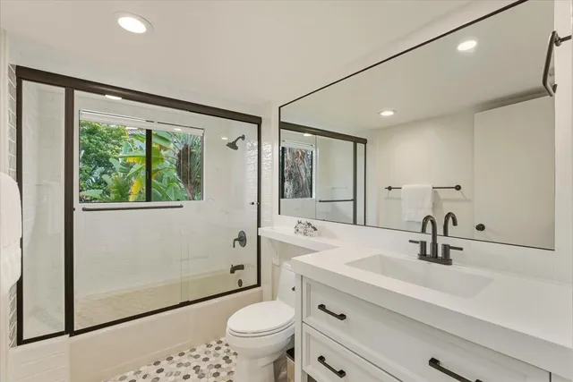 a living room with furniture a large window and a chandelier