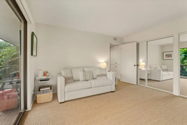 a front view of a house with a yard and mountain view