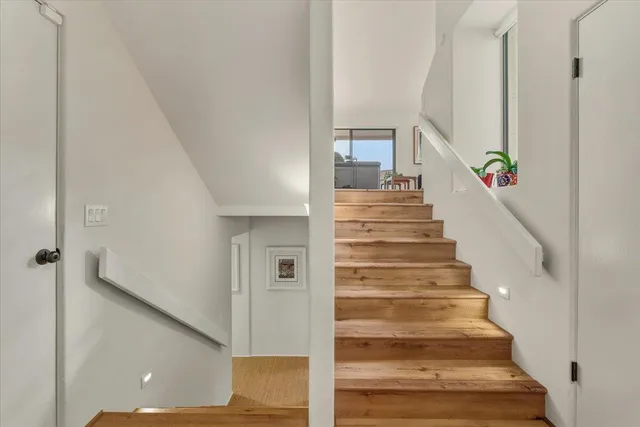 a living room with furniture a fireplace and a floor to ceiling window
