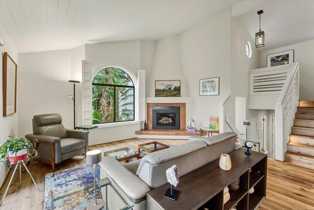 a living room with furniture and a floor to ceiling window