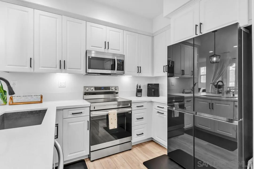 2811 Safflower Street Spring Valley, CA 91977 - Photo 6 of 28 a kitchen with cabinets stainless steel appliances and a counter space